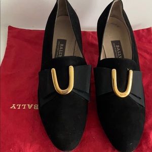 Black suede heels with gold accents by Bally